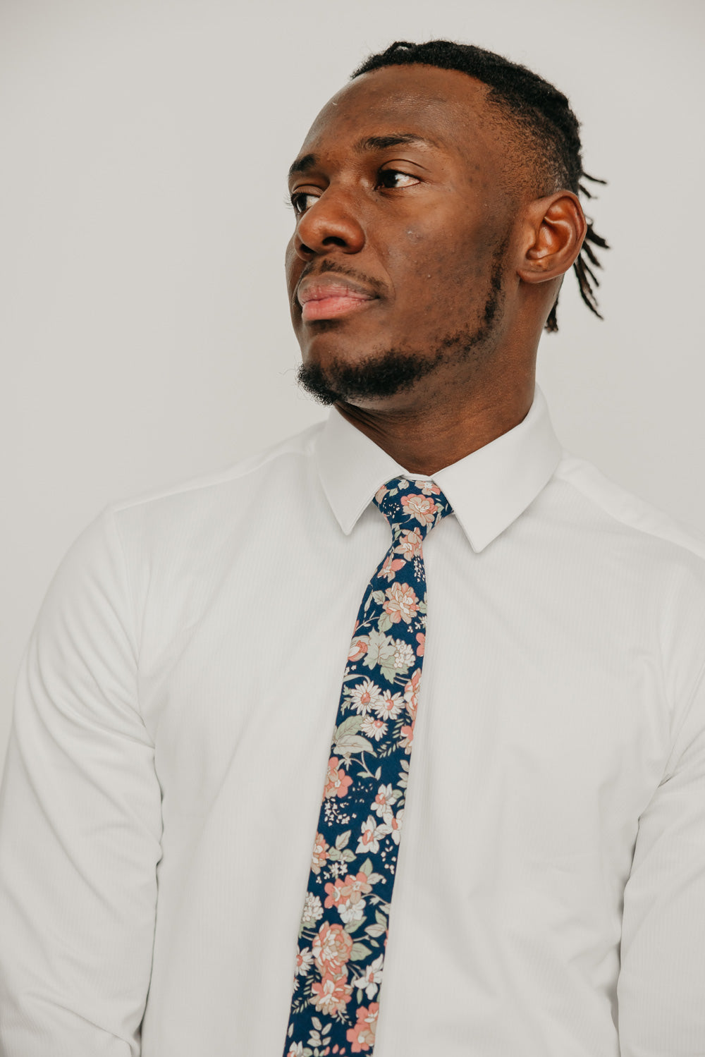 Lotus tie worn with a white shirt.