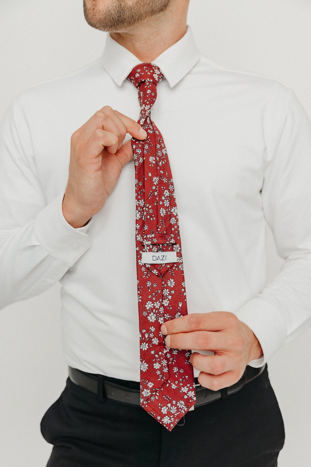 Mahogany tie worn with a white shirt, black belt and black pants.