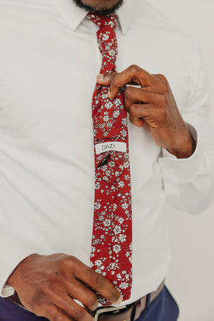 Mahogany tie worn with a white shirt, brown belt and blue pants.