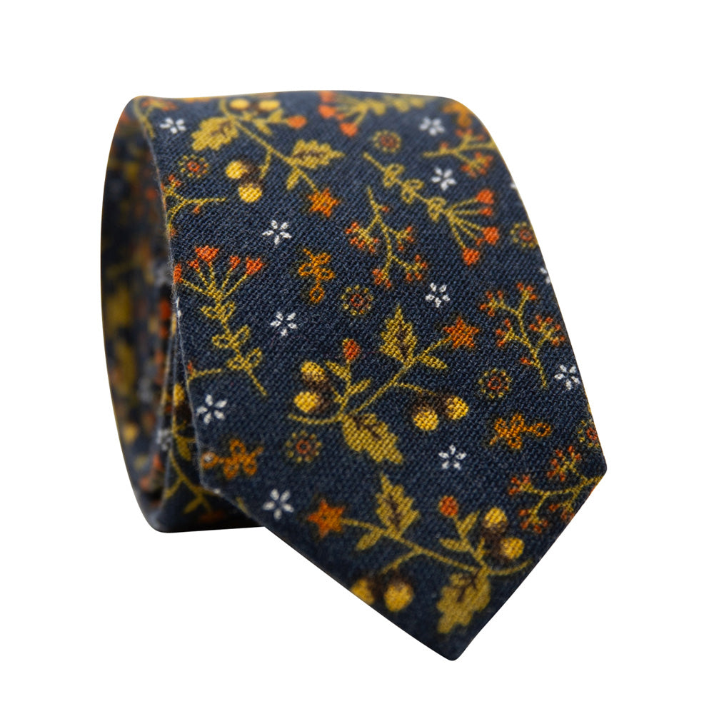 Maple Blossom Skinny Tie. Navy blue textured background with yellow gold, orange and white flowers and leaves throughout. 