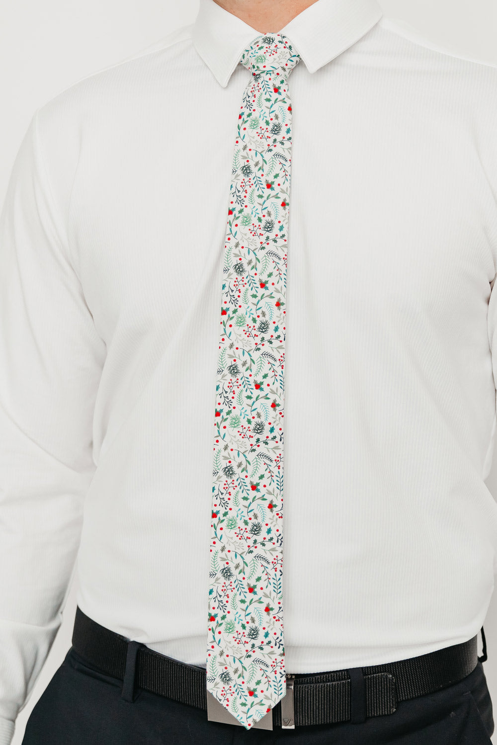 DAZI Mistletoe tie worn with a white shirt, black belt and black suit pants.