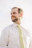 Pale Lime tie worn with a white shirt.