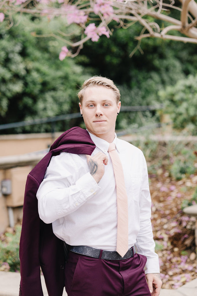 Pale Pink Tie worn with a white shirt and plum purple suit.