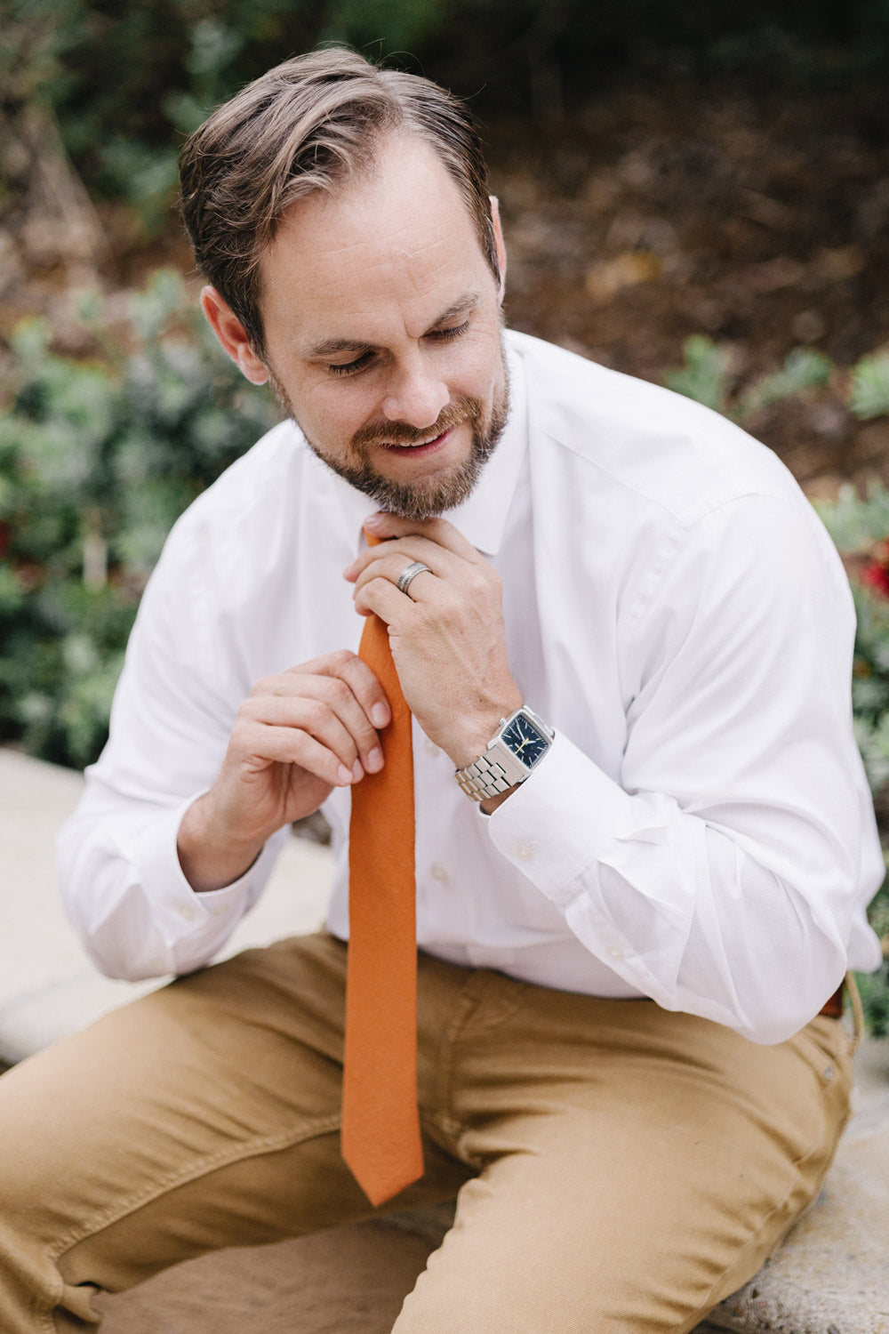 Pumpkin tie worn with a white shirt and tan pants.