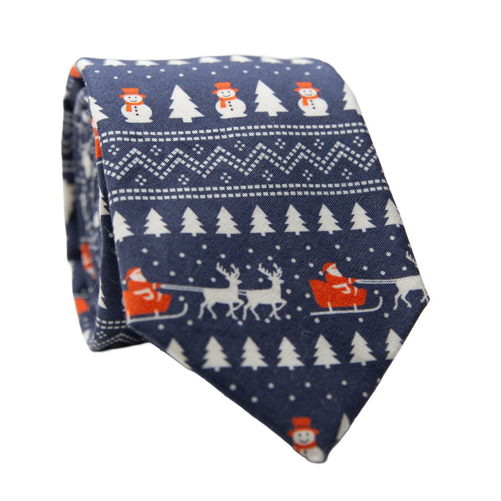 DAZI Reindeer Run Holiday Christmas Tie. Blue background with white trees and snowmen and reindeer and santa in a sleigh. 