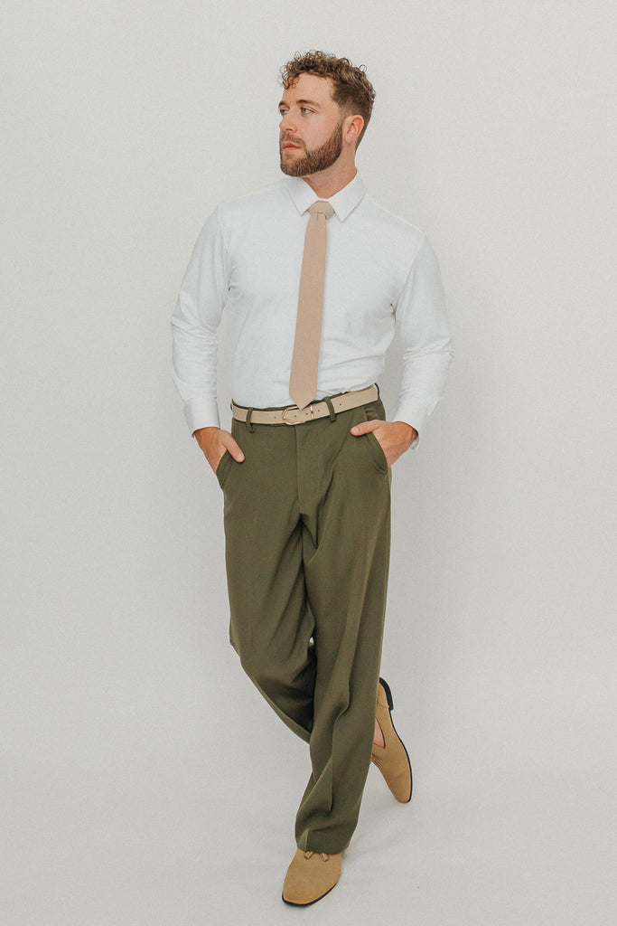 Sand tie worn with a white shirt, brown belt and olive green pants.
