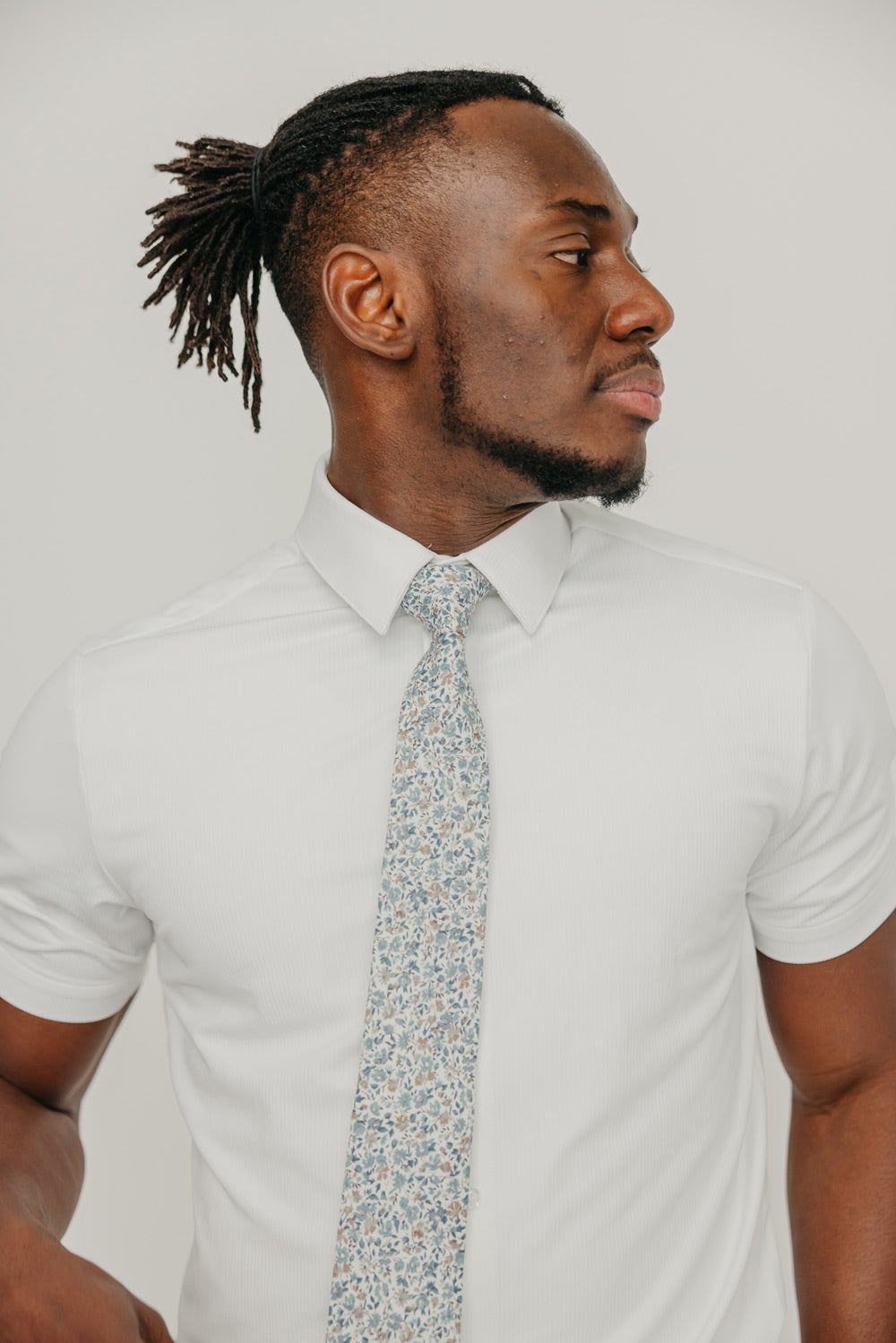 Scorpion Grass tie worn with a white shirt.