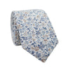Scorpion Grass Floral Skinny Tie. White background with small dusty blue and tan flowers throughout.