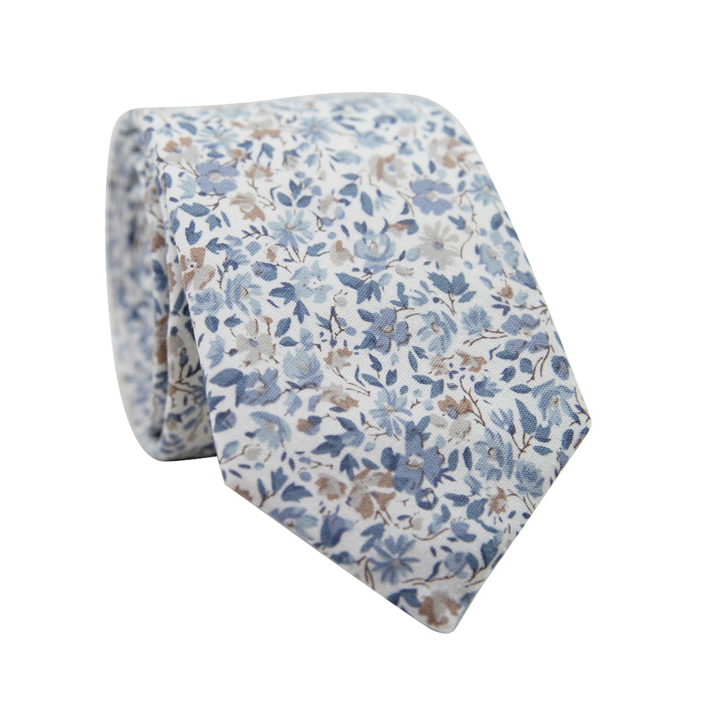 Scorpion Grass Floral Skinny Tie. White background with small dusty blue and tan flowers throughout.