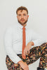 Sedona tie worn with a white shirt, black belt and floral pants.