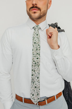 Silhouette tie worn with a white shirt, brown belt and gray pants.