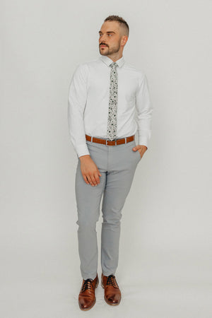 Silhouette tie worn with a white shirt, brown belt and gray pants.