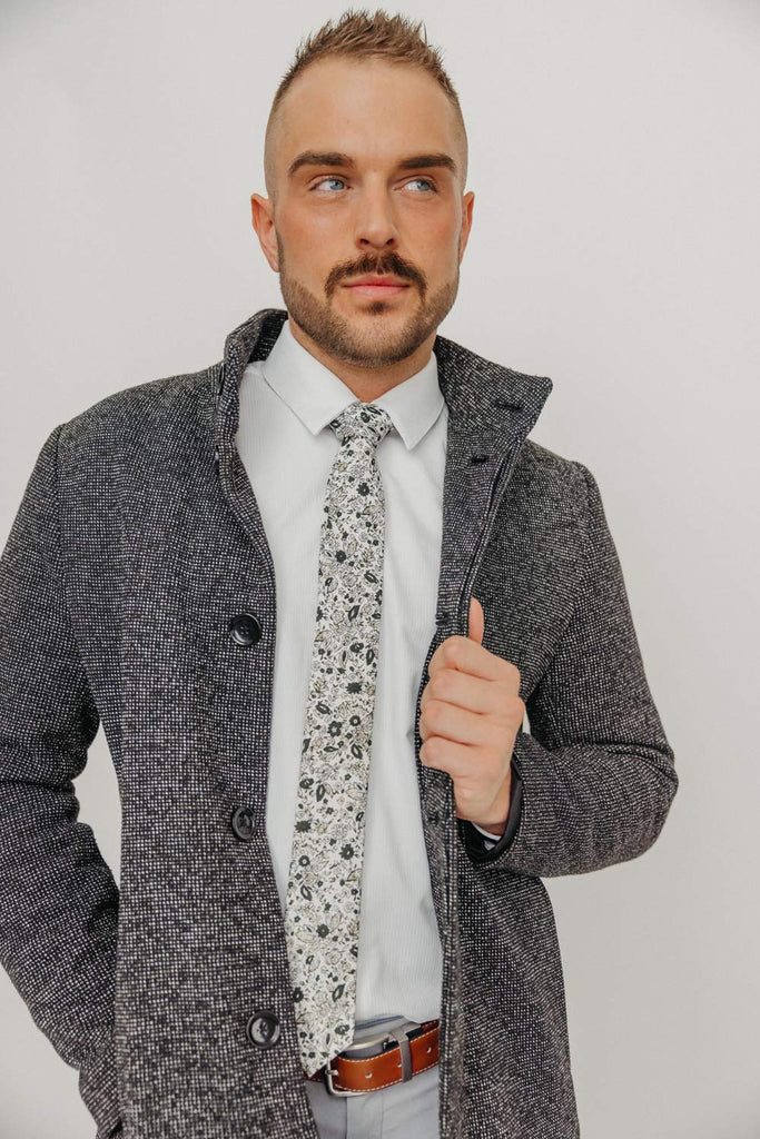 Silhouette tie worn with a white shirt, brown belt and gray pants.