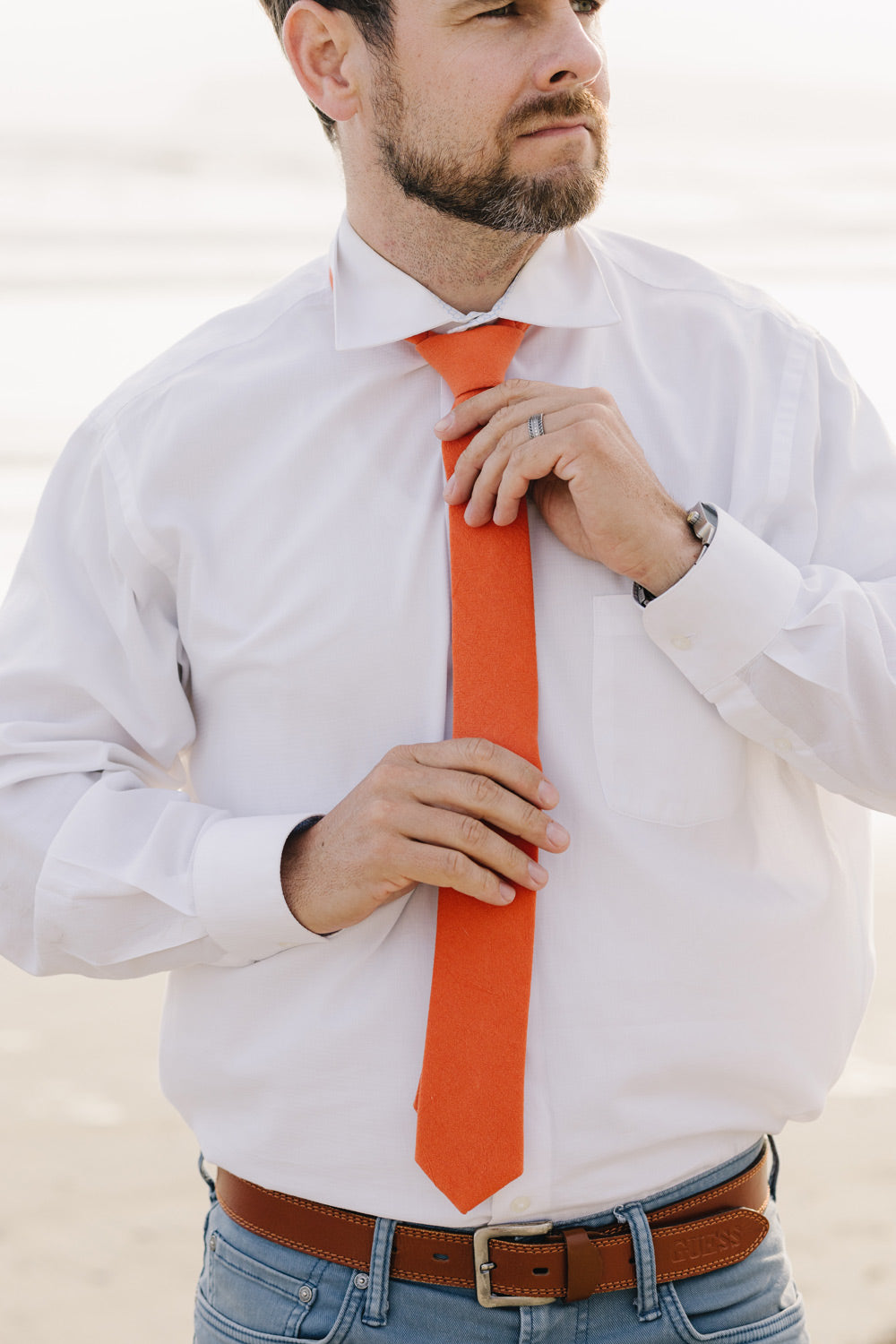 Tangerine tie worn with a white shirt.