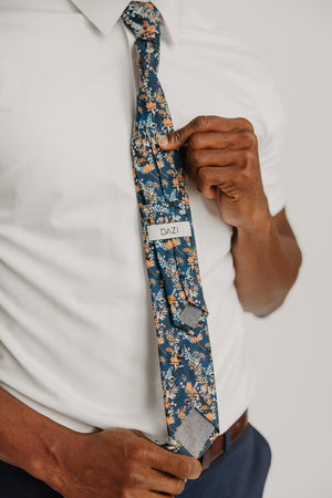 Tiger Lily tie worn with a white shirt, brown belt and blue pants.