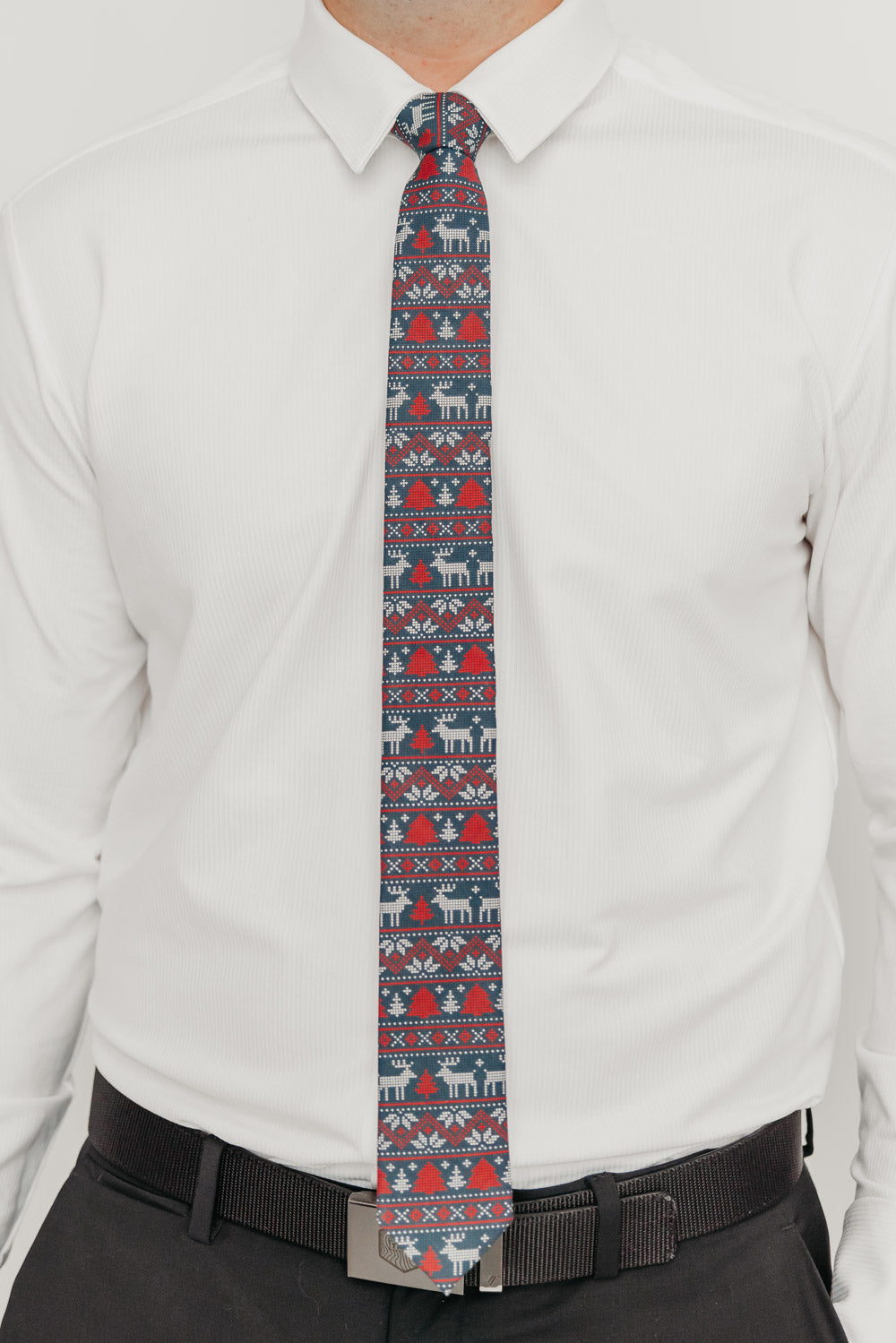 DAZI Winter Wonderland tie worn with a white shirt, black belt and black suit pants.