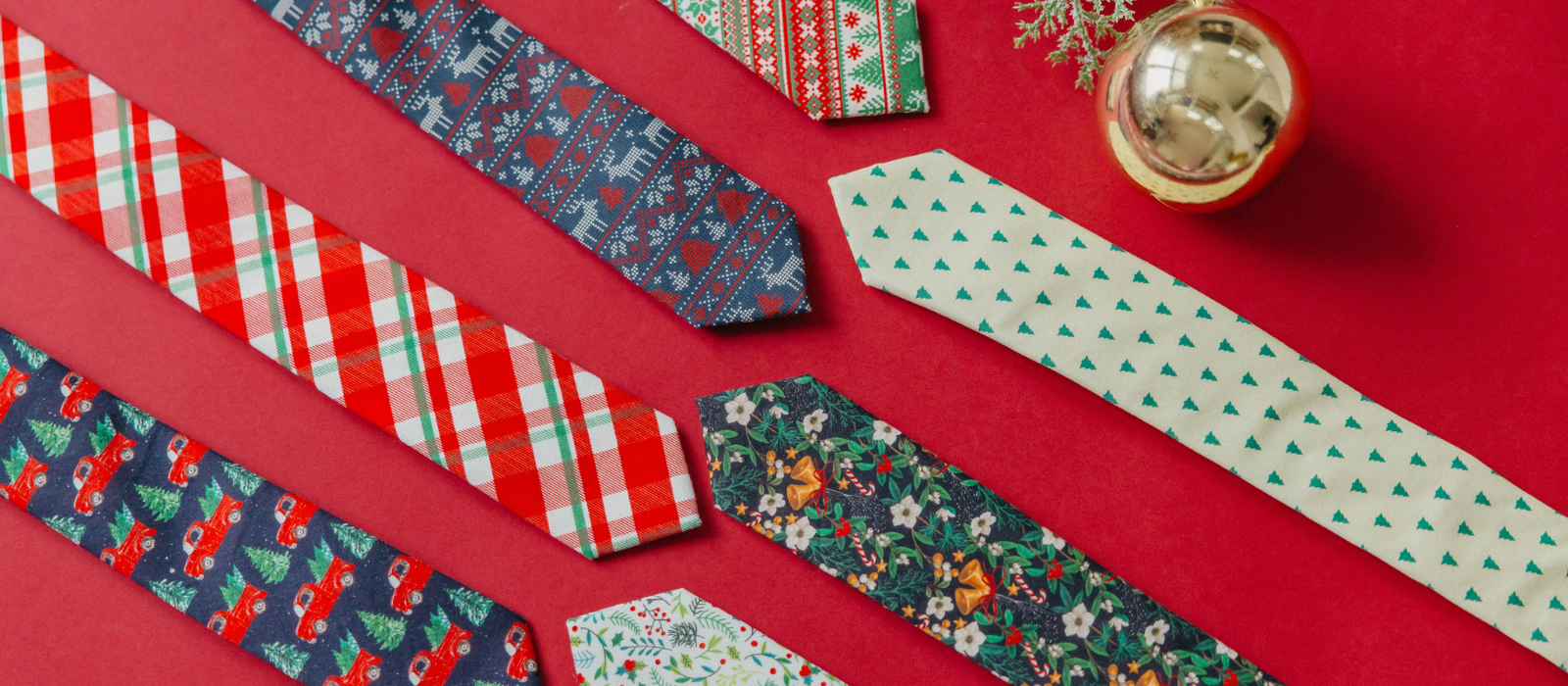 7 Limited Edition Christmas Print Ties on a red background. 