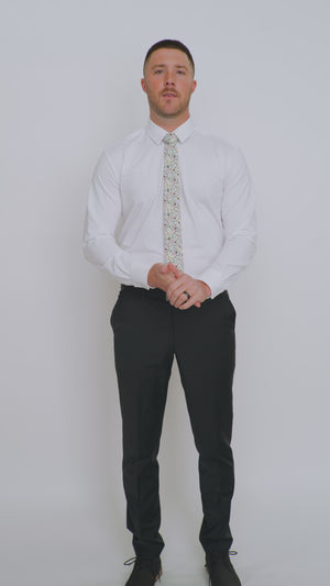 DAZI Mistletoe tie worn with a white shirt, black belt and black suit pants.