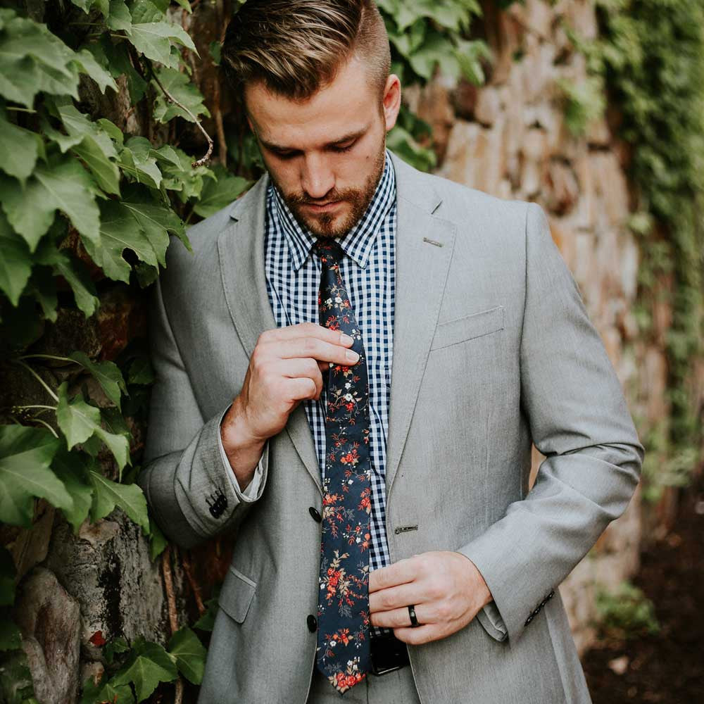 Coral Flor Tie on model wearing blue plaid shirt and gray suit jacket