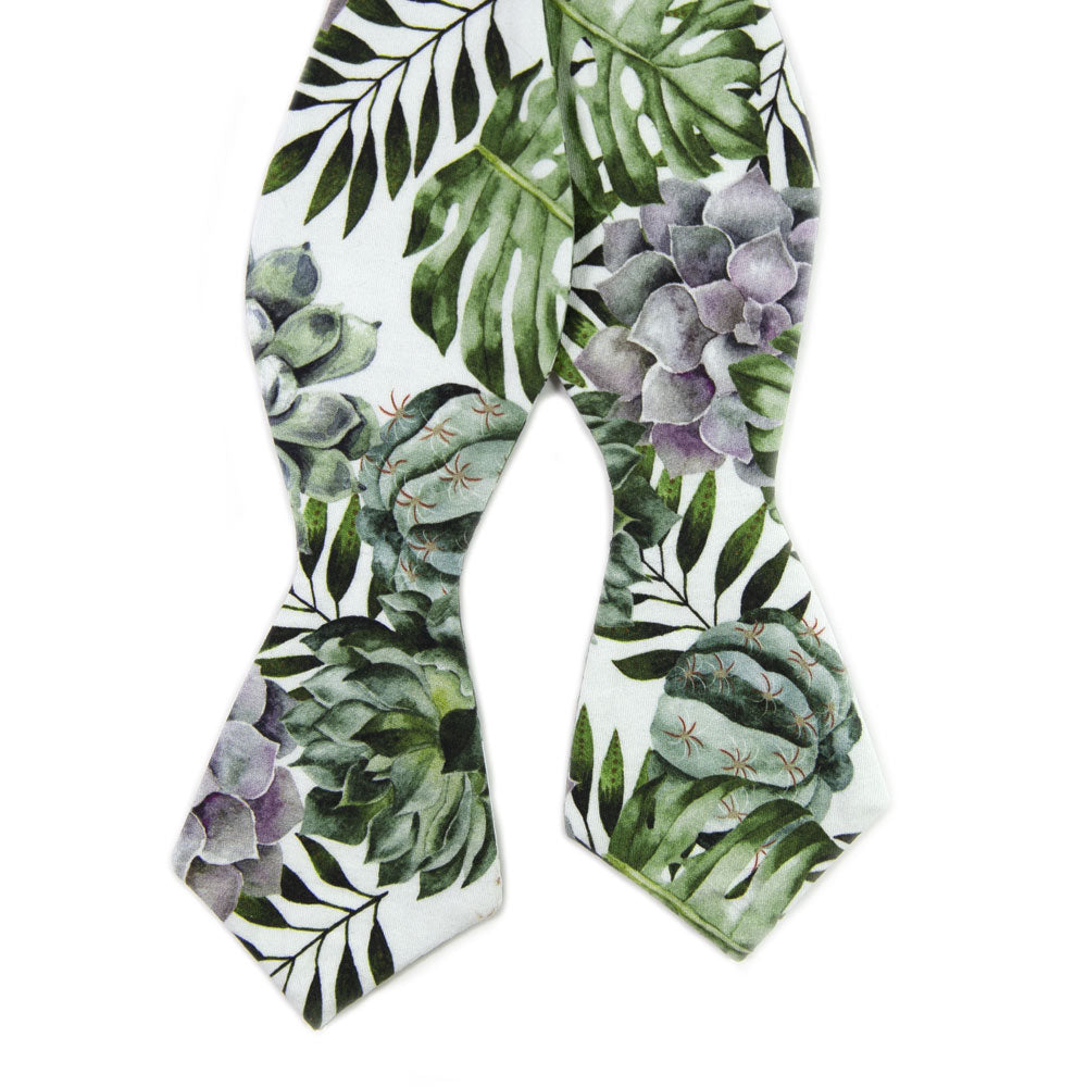 Aloe Self Tie Bow Tie. White background with big green succulents and leaves, and also purple succulents.