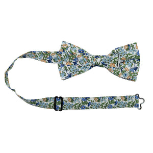 Alpine Blum Pre-Tied Bow Tie with Adjustable Neck Strap. White background with small blue and yellow flowers, small green leaves throughout.