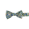Alpine Blum Pre-Tied Bow Tie. White background with small blue and yellow flowers, small green leaves throughout.