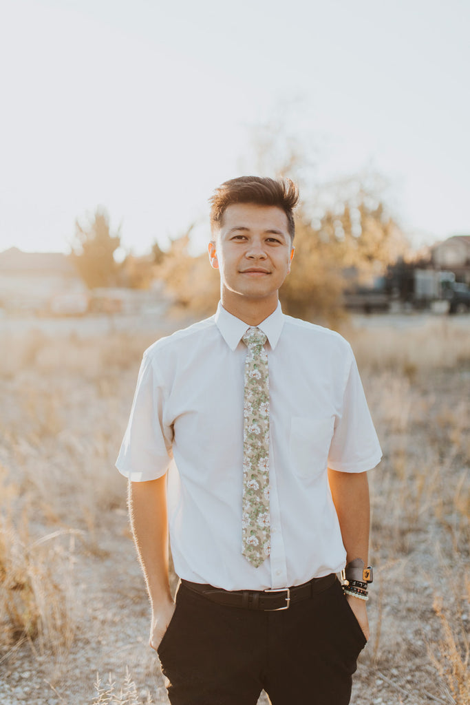 Alyssum tie worn with a white shirt, black belt and black pants.