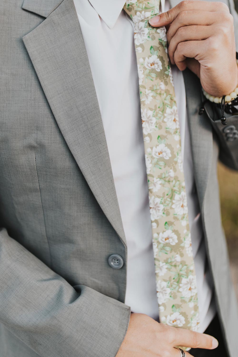 Alyssum tie worn with a white shirt, gray suit jacket, black belt and black pants.