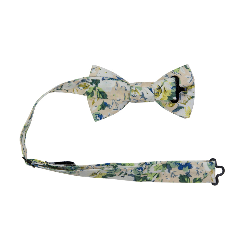 Antiquity Pre-Tied Bow Tie with adjustable neck strap. Off-white cream background with a variety of white, sage green, yellow gold and light navy blue flowers scattered throughout.