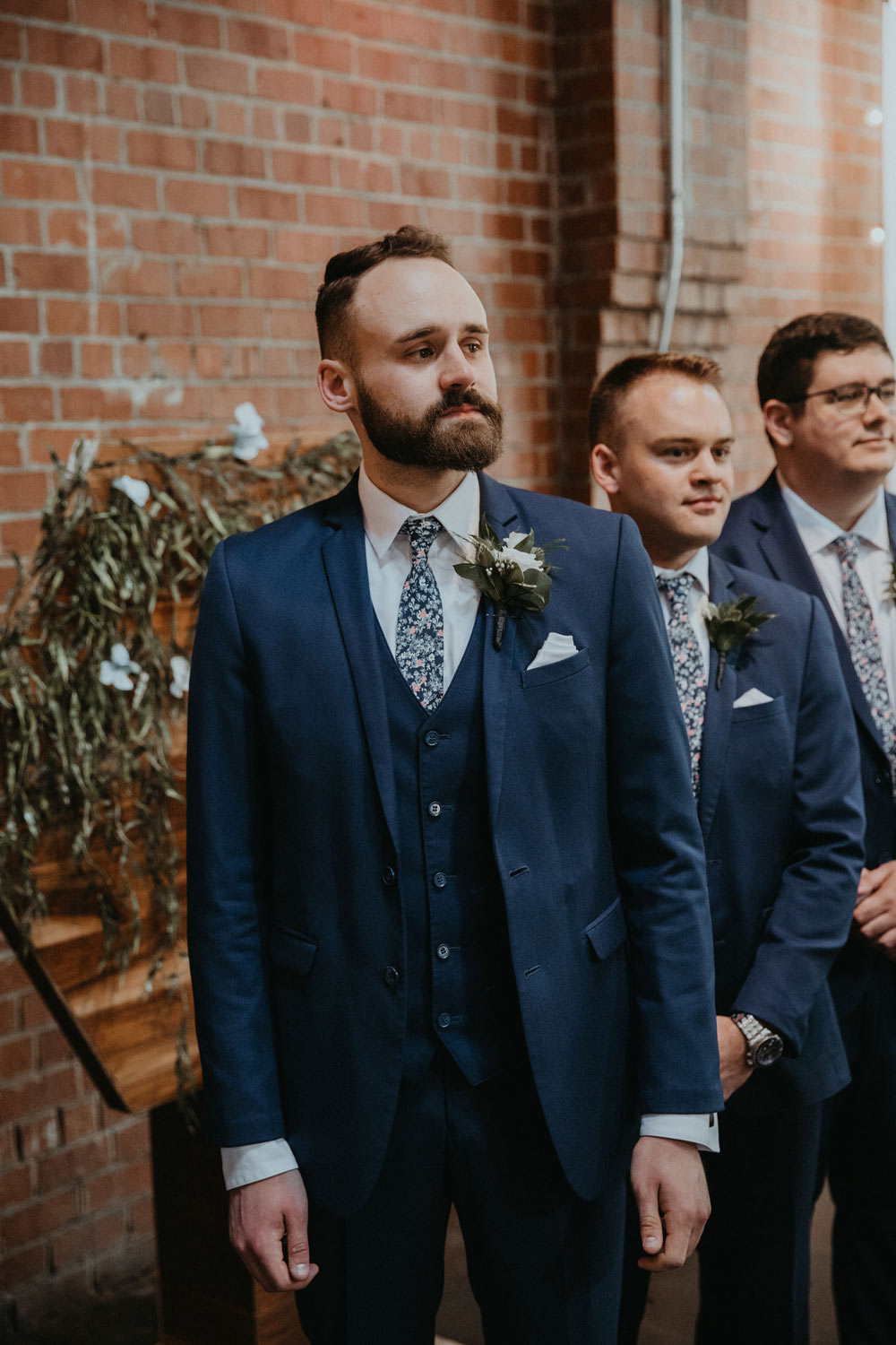 Atlanta tie worn by three groomsmen at a wedding with white shirts and navy blue suits. 