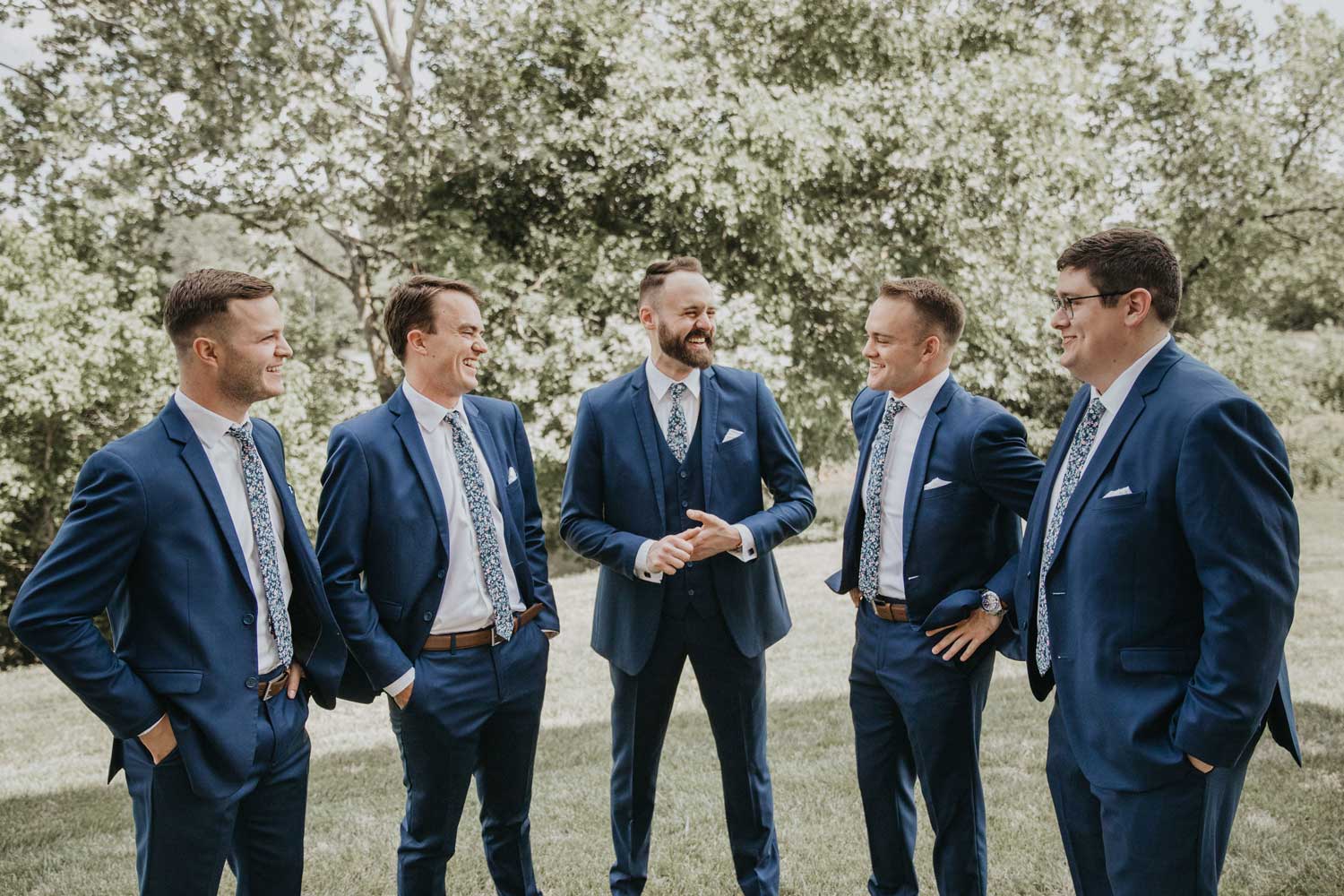 Atlanta tie worn by five groomsmen at a wedding with white shirts and navy blue suits. 