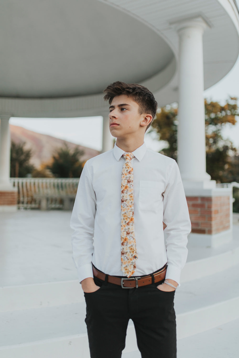Autumn Cascade Tie worn with a white shirt and black pants.