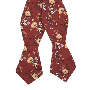 Autumn Self Tie Bow Tie. Red background with tan, peach and white flowers with black stems and leaves.