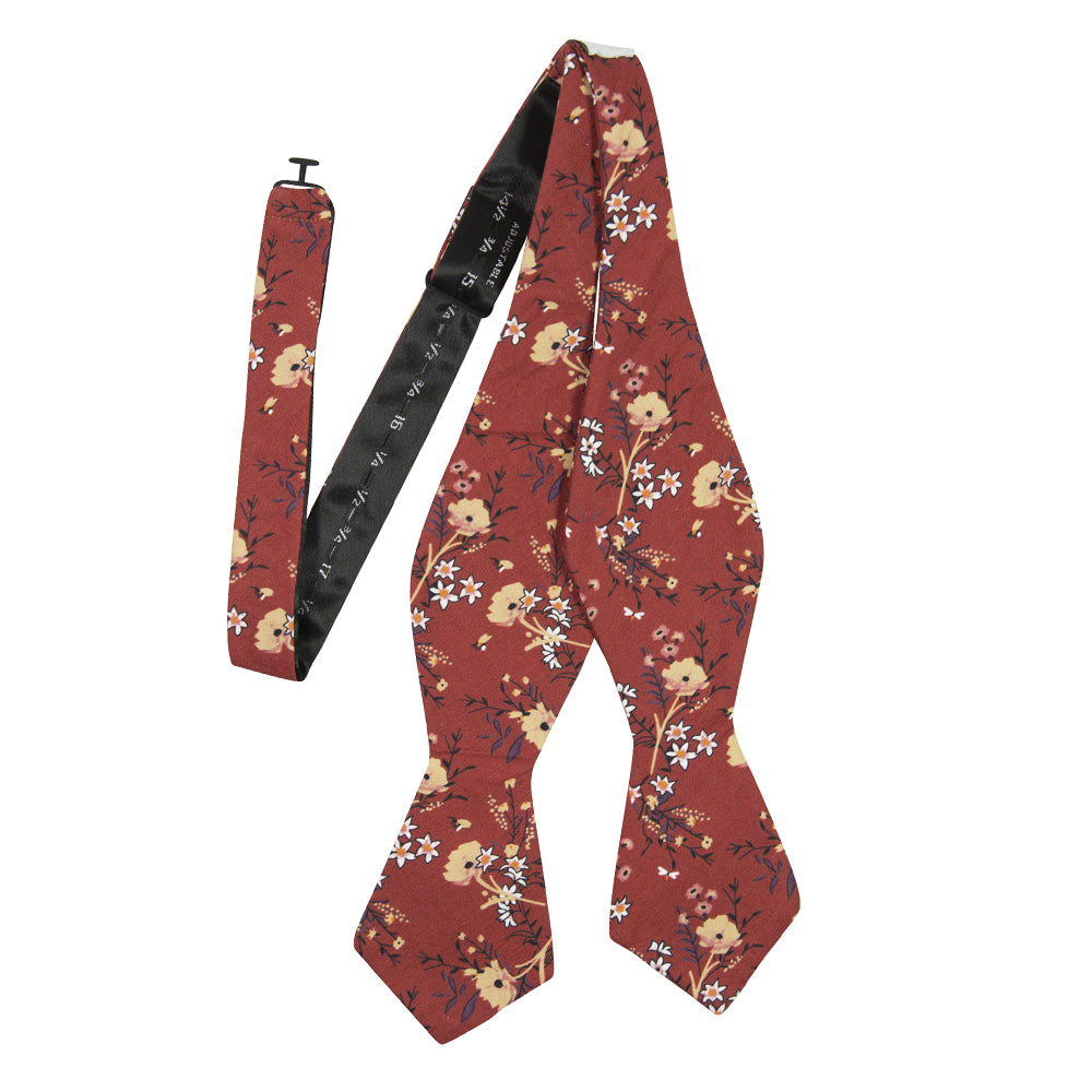 Autumn Self Tie Bow Tie. Red background with tan, peach and white flowers with black stems and leaves.