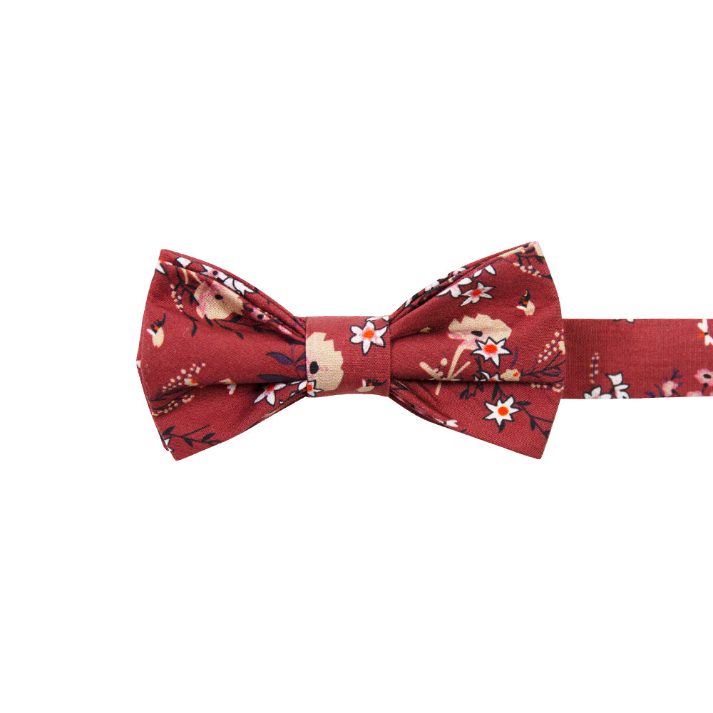 Autumn Pre-Tied Bow Tie. Red background with tan, peach and white flowers with black stems and leaves.