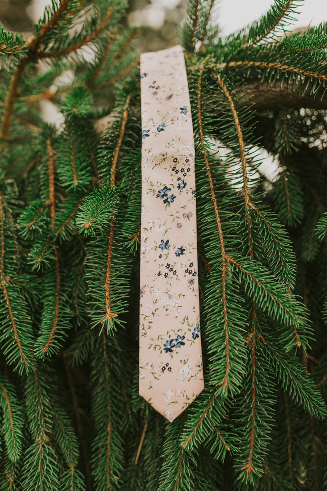 Babys Breath tie hanging from branches in a pine tree.