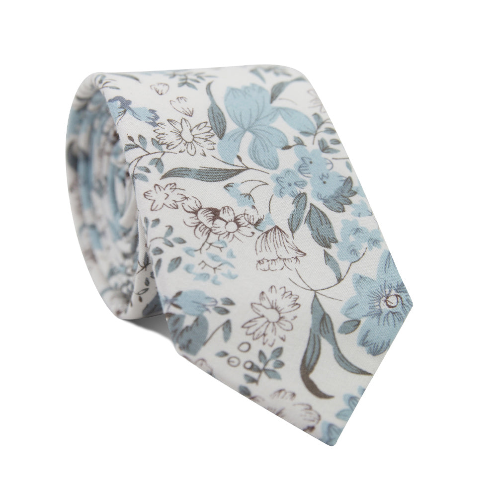 Baltic Skinny Tie. White background with various sizes of flowers and leaves in multiple shades of dusty blue.
