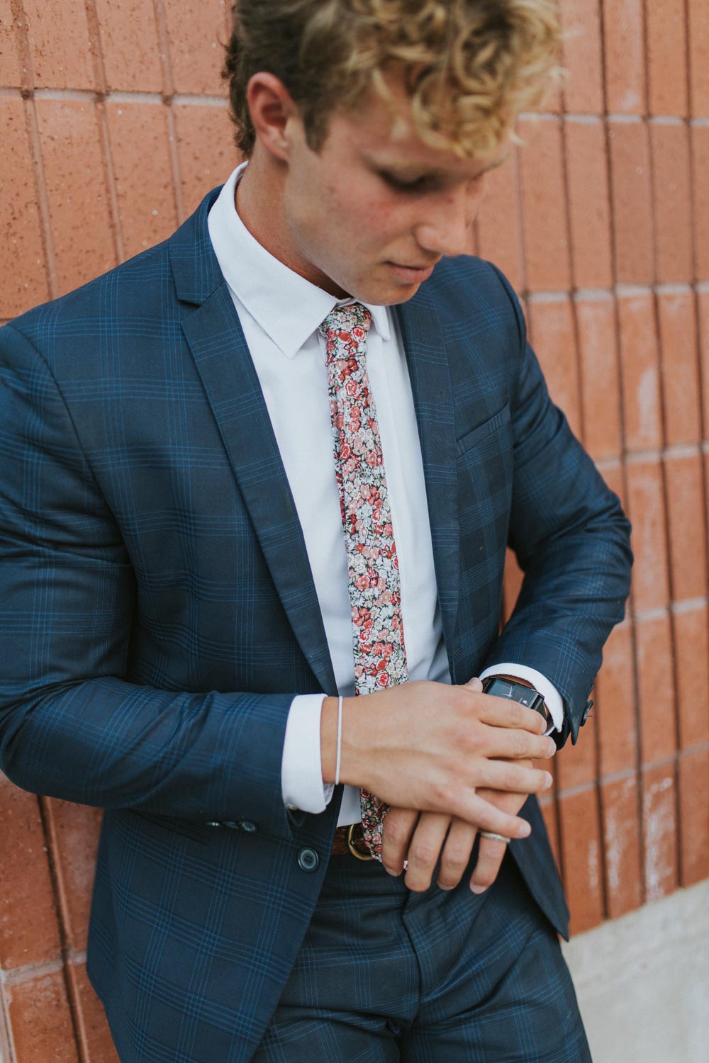 Bed of Roses tie worn with a white shirt and blue suit jacket.