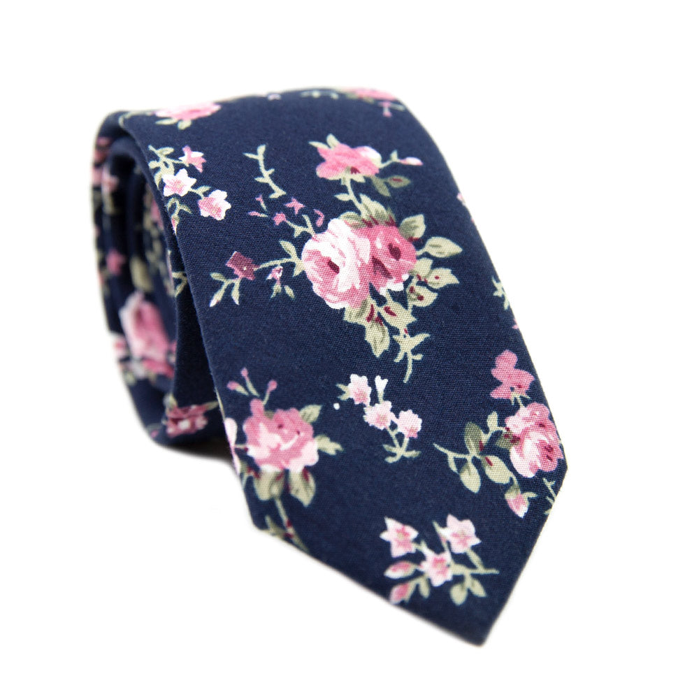 Bittersweet Skinny Tie. Navy blue background, blush pink flowers and green leaves.