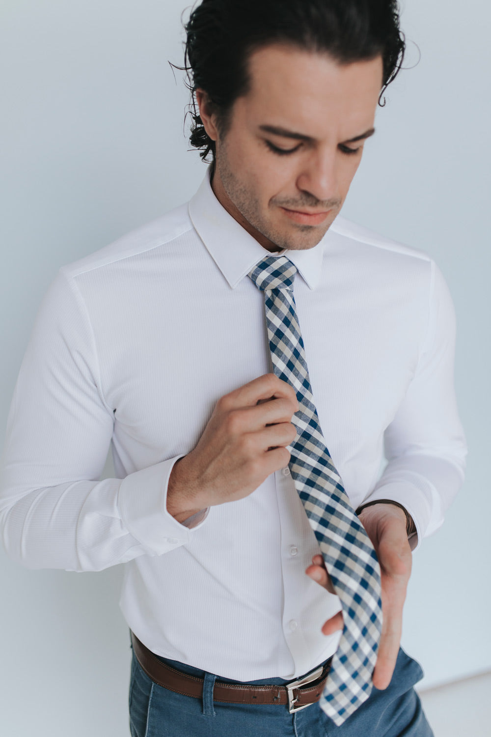 Blazer Tie worn with a white shirt, brown belt and blue pants.