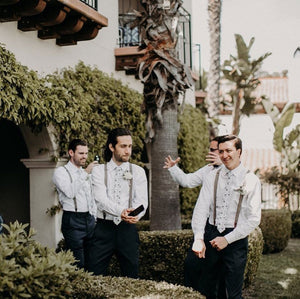 Four groomsmen at a wedding wearing Blue Bloom tie with white shirts. 