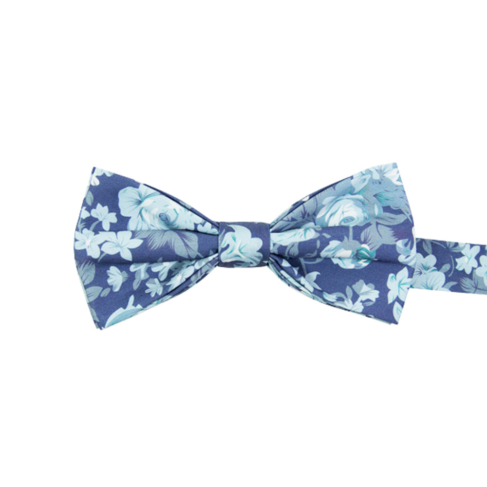 Blue Tropic Pre-Tied Bow Tie. Dusty blue background with light blue leaves and flowers, some turquoise accents throughout.