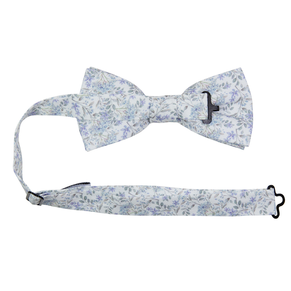 Bluebell Pre-Tied Bow Tie with adjustable neck strap. White background with small dusty blue flowers and sage green stems and leaves throughout.
