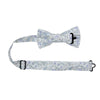 Bluebell Pre-Tied Bow Tie with adjustable neck strap. White background with small dusty blue flowers and sage green stems and leaves throughout.