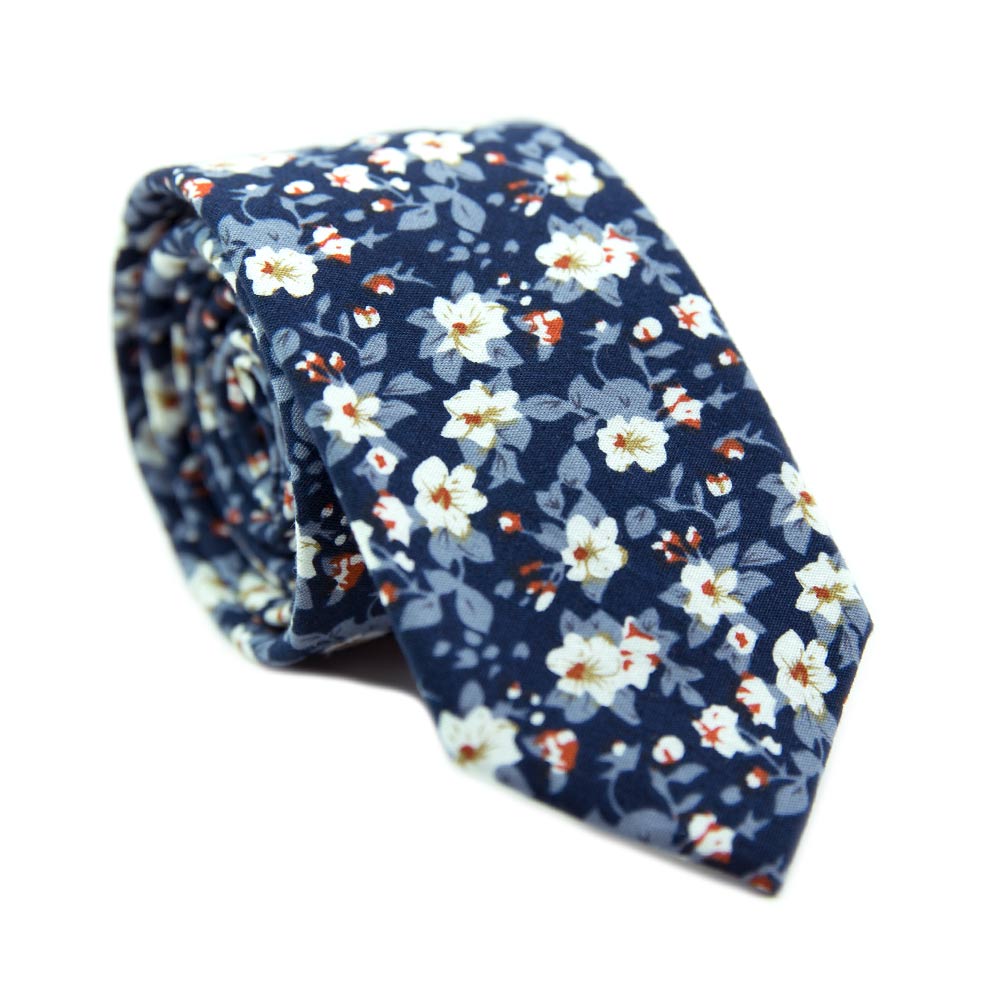 Blueberry Bliss skinny tie. Navy background, light blue leaves, and small white flowers with a little red center.