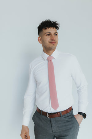 Blush Tie worn with a white shirt, brown belt and gray pants.