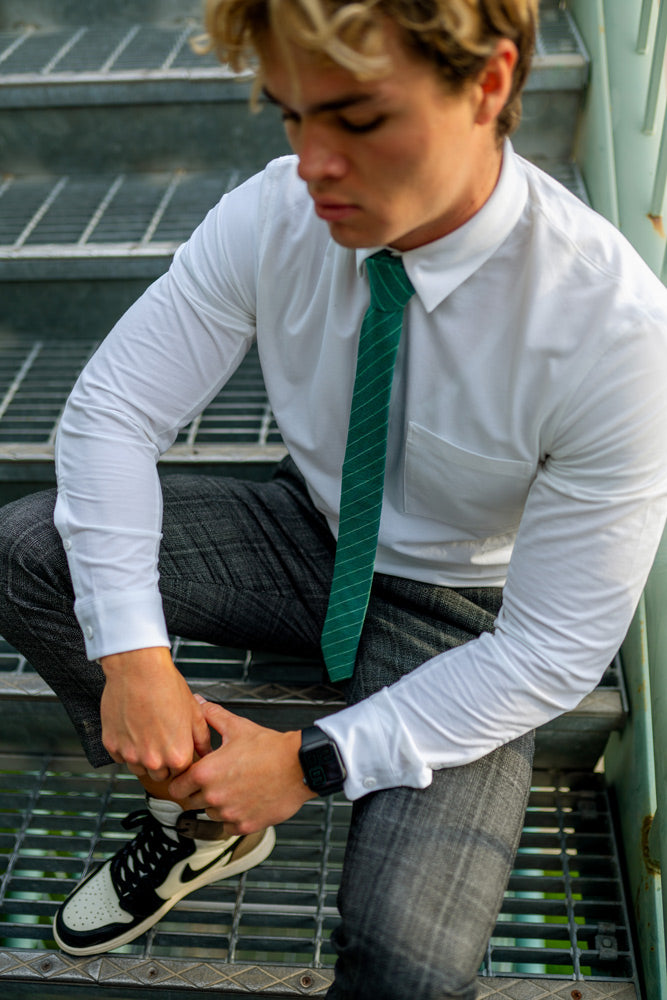 Boarderline tie worn with a white shirt and charcoal gray plaid pants.
