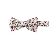 Burning Brush Pre-Tied Bow Tie. White background with small red flowers and green leafy vines throughout.