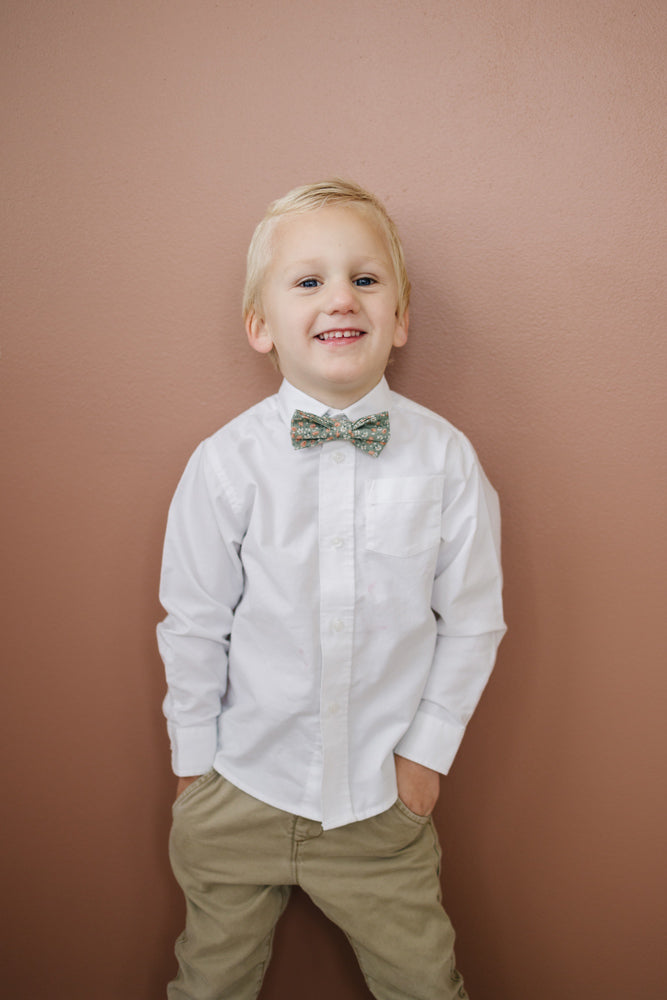 Calla Lily pre-tied bow tie worn with a white shirt and tan pants.