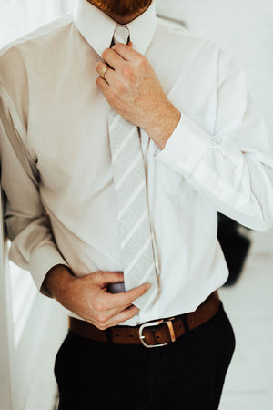 Camarillo tie worn with a white shirt, brown belt and black pants.